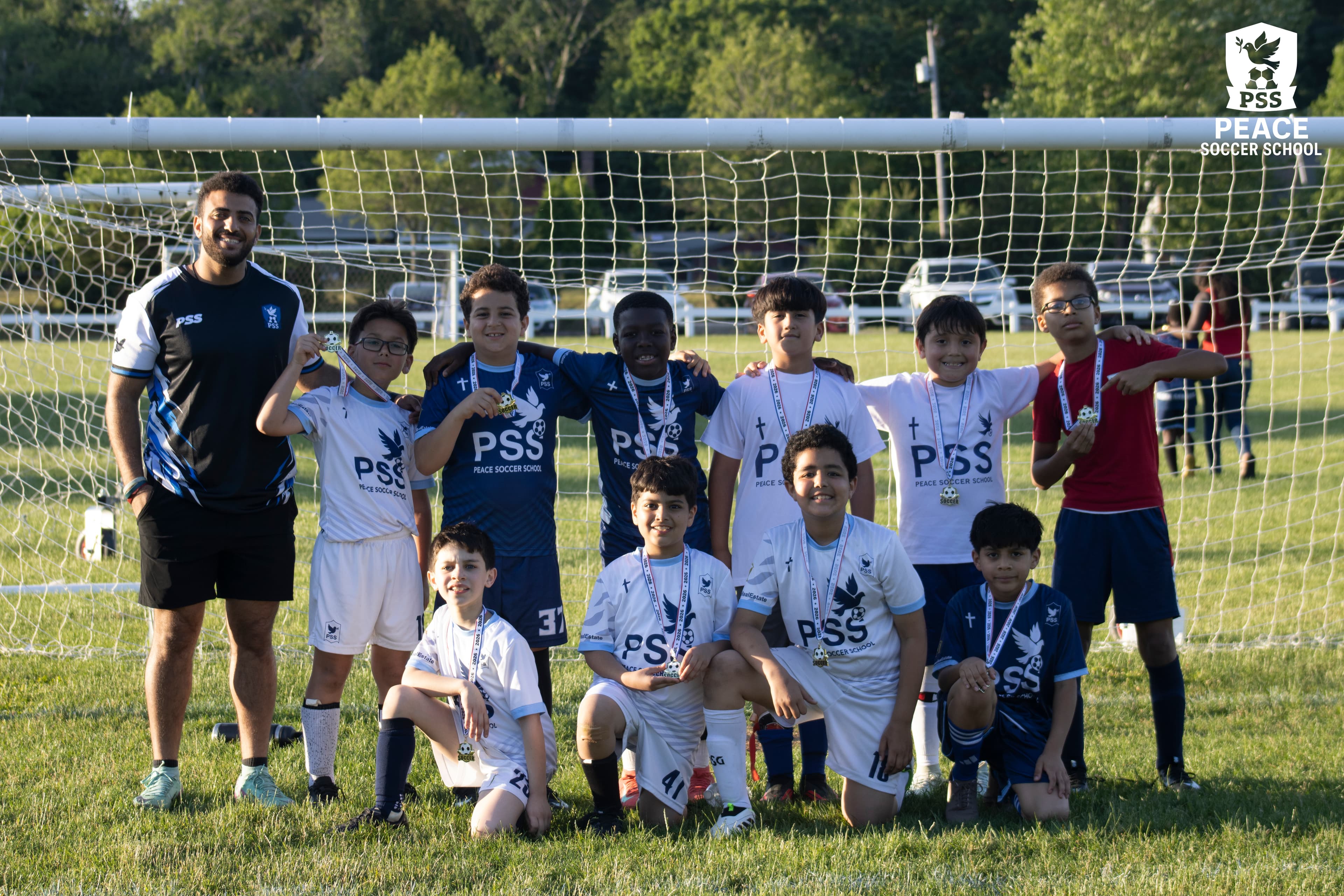 Christian youth soccer coach leading practice drills at Peace Soccer School