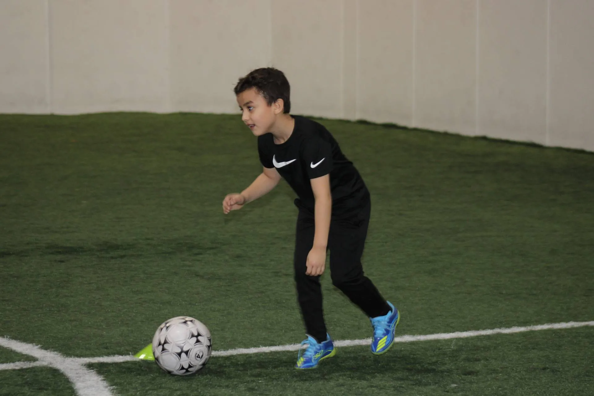 Peace Soccer School coach instructing young soccer players during training session