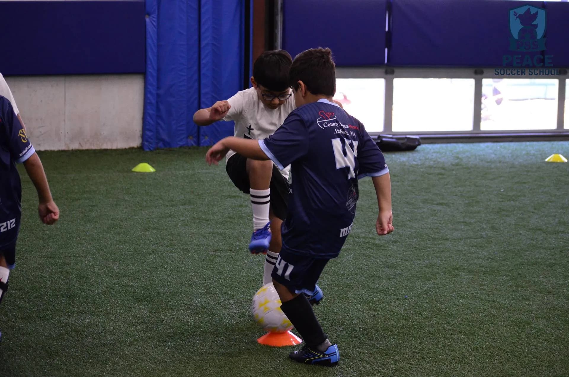 Youth soccer players in game action at Peace Soccer School Rehoboth MA
