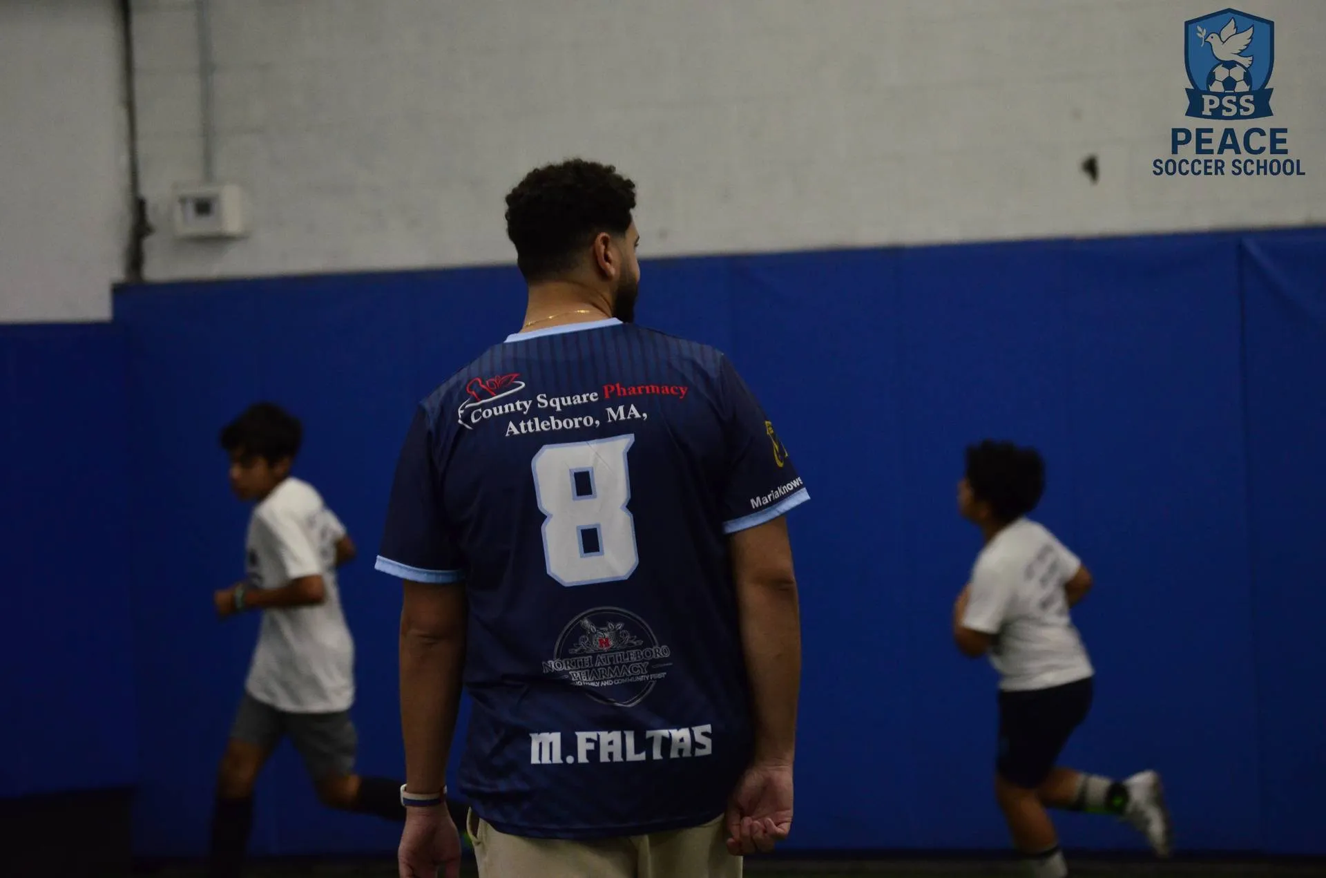 Christian youth soccer coach leading practice drills at Peace Soccer School