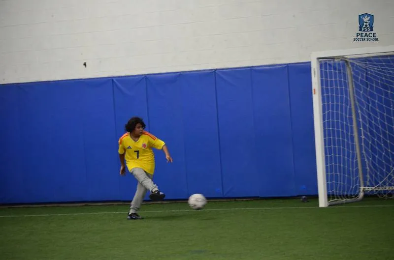 Peace Soccer School player receiving award at youth soccer academy